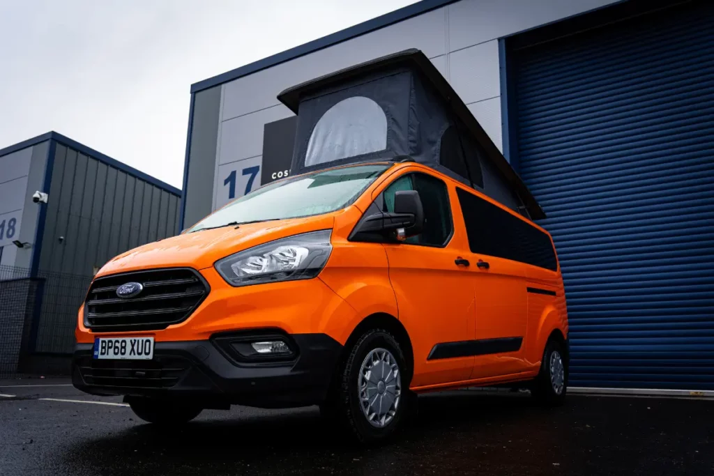 Orange Ford Transit Custom campervan Conversion with pop top