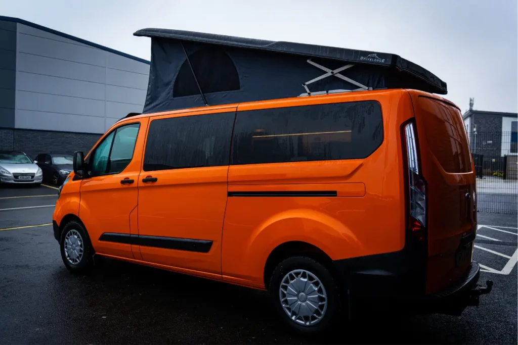 Orange Ford Transit Custom with Pop Top Roof